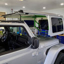 TopLift Pro V2 hardtop removal and storage tool for Jeep Wrangler and Ford Bronco, shown in use with shipping packaging.